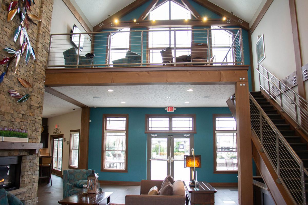 Spacious living room with a loft area and modern design elements.
