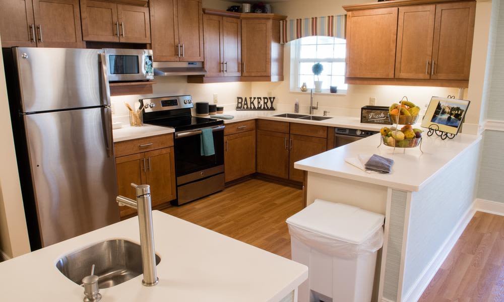 A modern kitchen with wooden cabinets and stainless steel appliances.