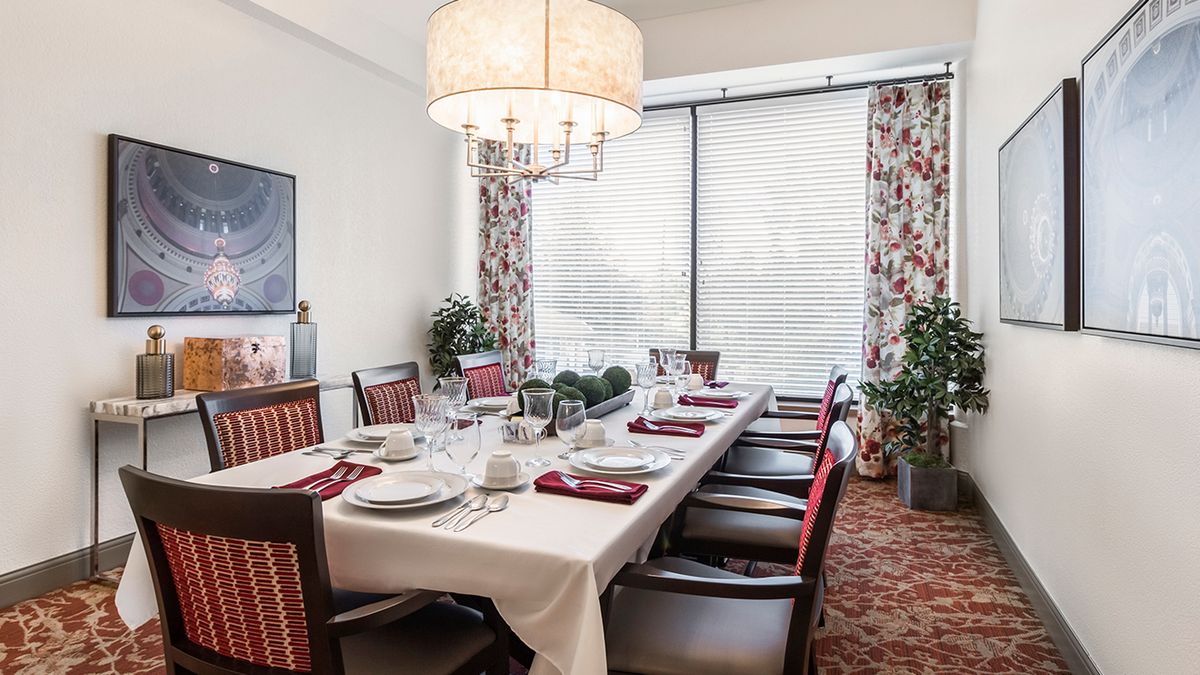 A beautifully set dining table with elegant decor and lighting.