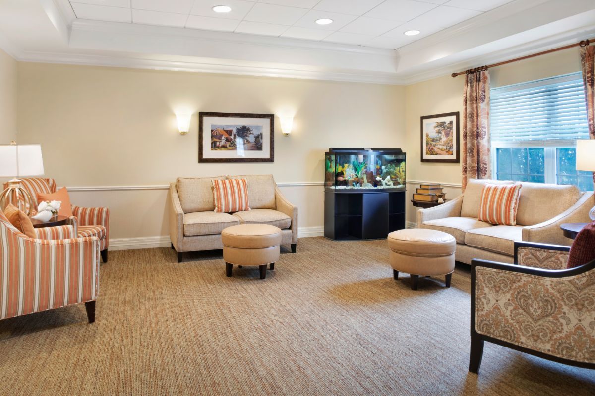 A cozy living room with comfortable seating and an aquarium.