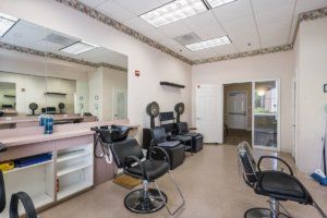 A hair salon interior with styling chairs and mirrors.