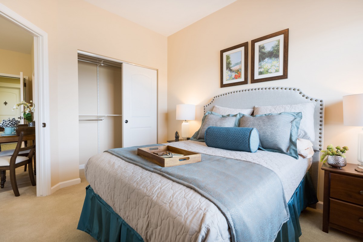 A cozy bedroom with stylish decor, featuring a neatly made bed and a soft color palette.