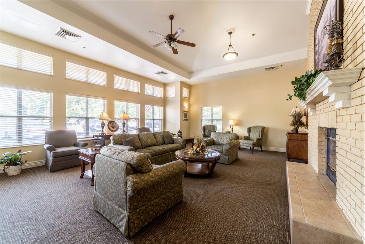 A spacious and elegant living room with comfortable seating and large windows.
