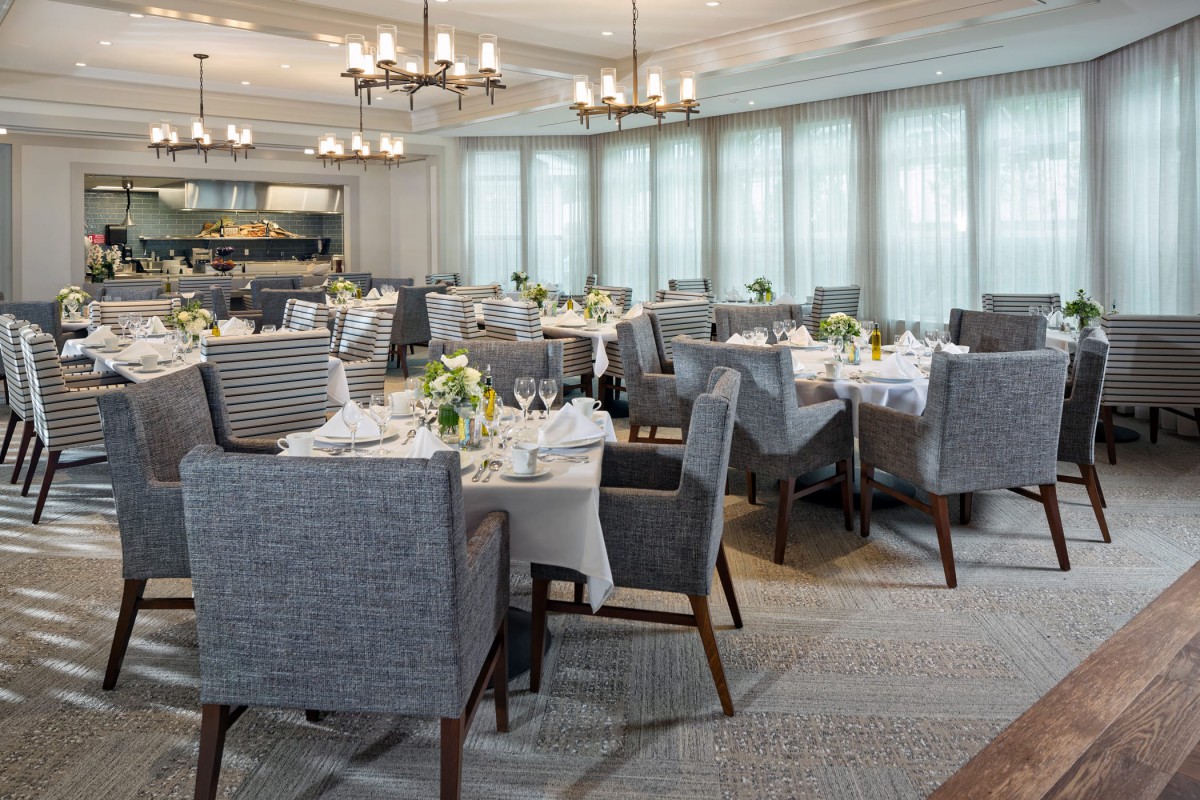 Elegant dining room set with beautifully decorated tables and comfortable chairs.