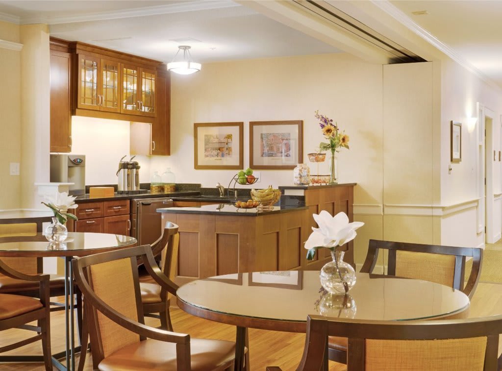 A modern kitchen and dining area with wooden furniture and elegant decor.