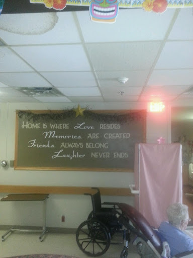 A chalkboard displaying messages of care in a hospital setting.