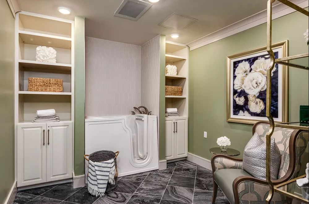 Elegant laundry room with built-in shelves and a marble floor.