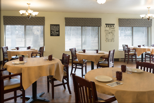 A cozy dining area featuring neatly arranged tables and chairs, perfect for casual meals.