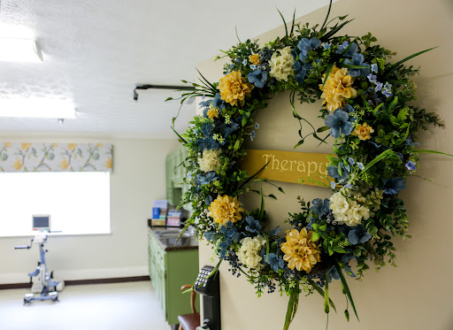A beautifully arranged floral wreath adorned with yellow and blue flowers, adding a touch of nature to the kitchen space.