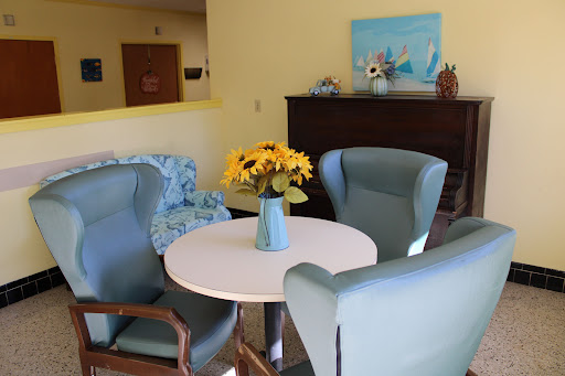 A cozy seating area adorned with a vase of flowers, creating a warm and inviting atmosphere.