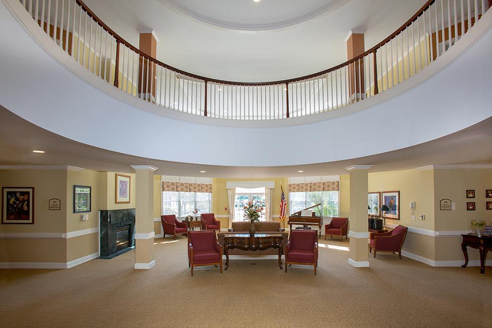 Spacious lobby with elegant furniture and a balcony view.