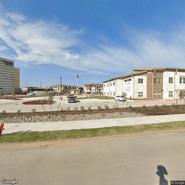A view of a residential area with modern buildings under a clear blue sky.