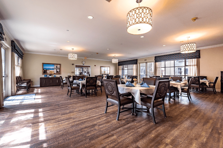 A spacious dining area with elegantly set tables and comfortable seating.