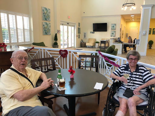 Two elderly individuals enjoying a moment in a warm and inviting communal space.