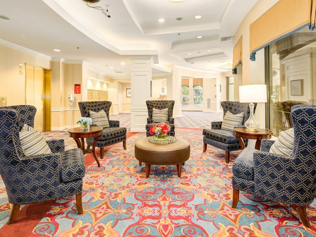 Elegant lobby with comfortable seating and colorful carpet.