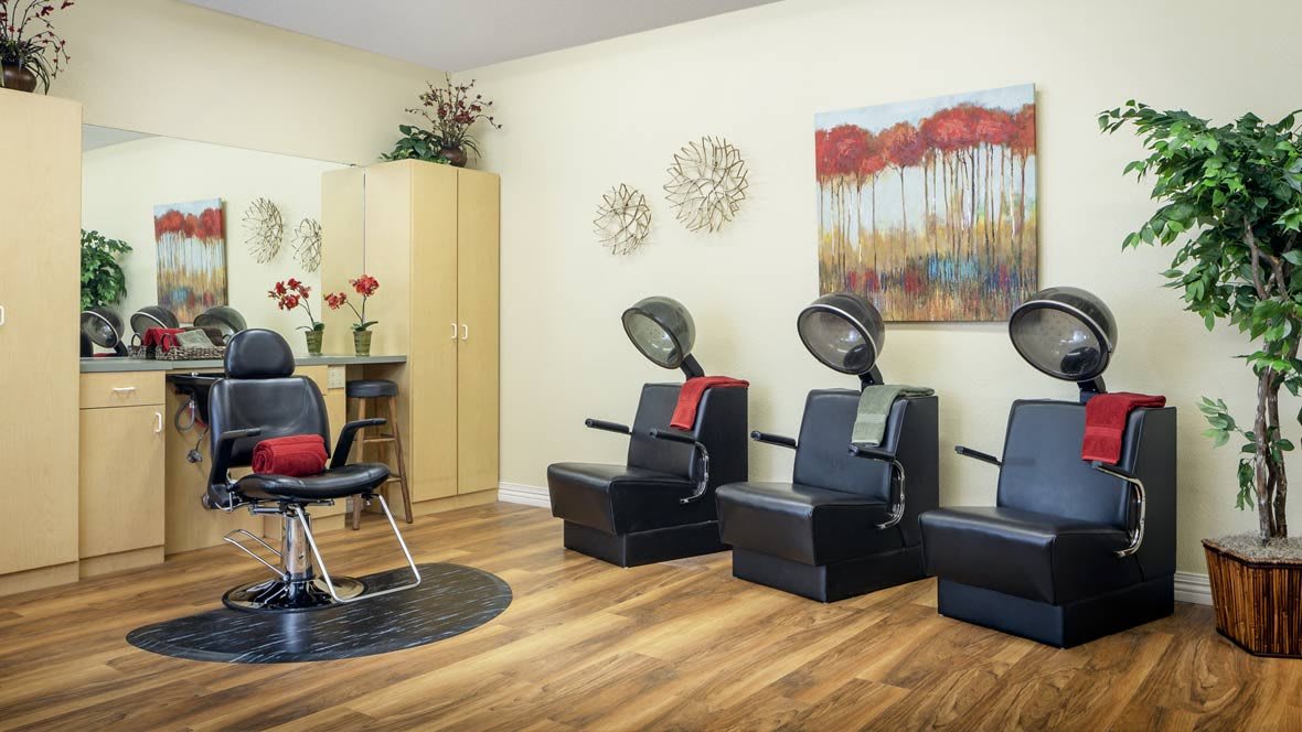A modern salon interior featuring hair drying chairs and stylish decor.