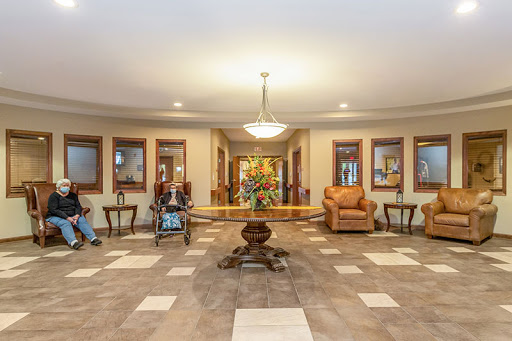 A spacious and welcoming lobby featuring comfortable seating, elegant decor, and natural lighting.