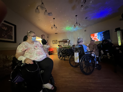 Residents enjoying a vibrant social event in an assisted living facility.