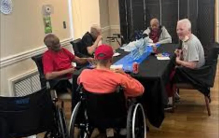 A group of people seated around a table in an indoor setting.