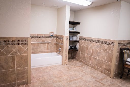 A spacious and modern bathroom featuring a bathtub and tiled walls.