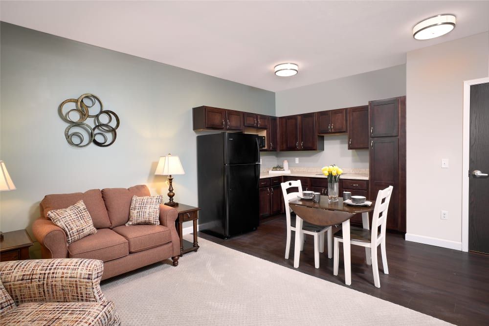A cozy open-plan living space with a kitchen, dining area, and seating.