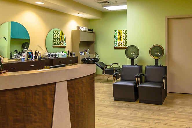A modern salon interior with styling chairs and hair dryers.