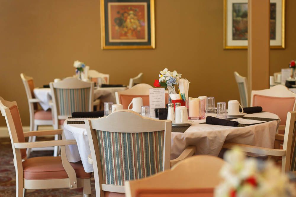A cozy restaurant interior with neatly set tables and chairs, adorned with simple decor.