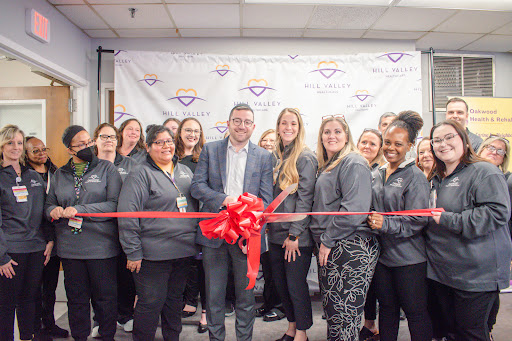 A successful ribbon-cutting ceremony celebrating the opening of a new business location with an enthusiastic team.