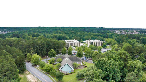 An aerial view showcasing a blend of urban buildings surrounded by lush greenery.