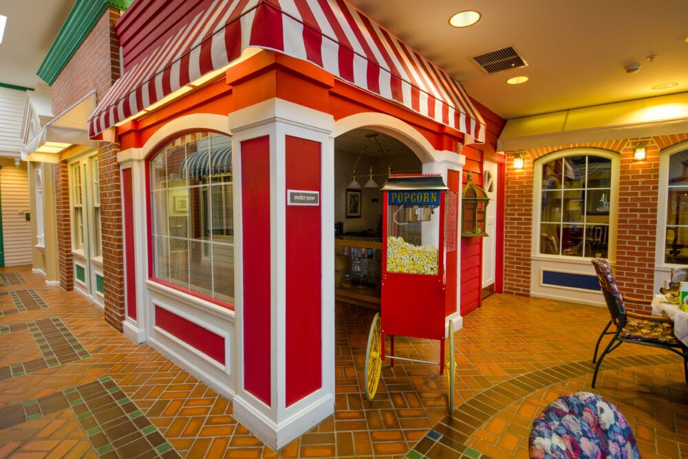 A charming storefront with a red and white striped awning and colorful decor.