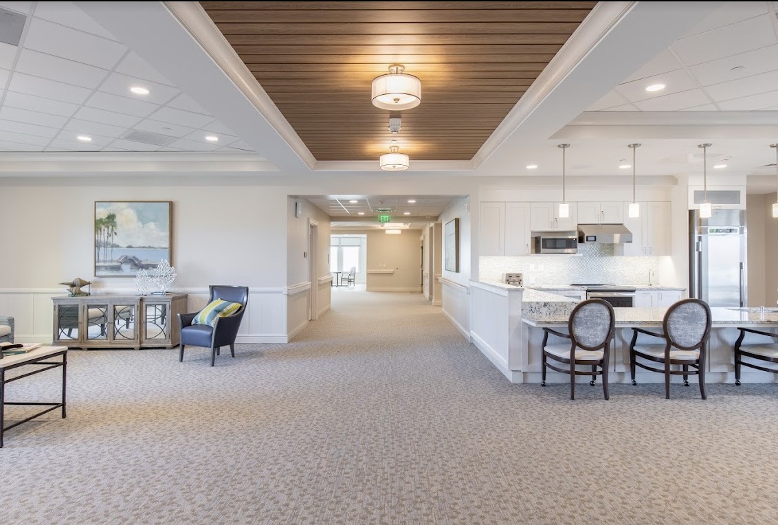A modern interior living space with a seating area and open kitchen.