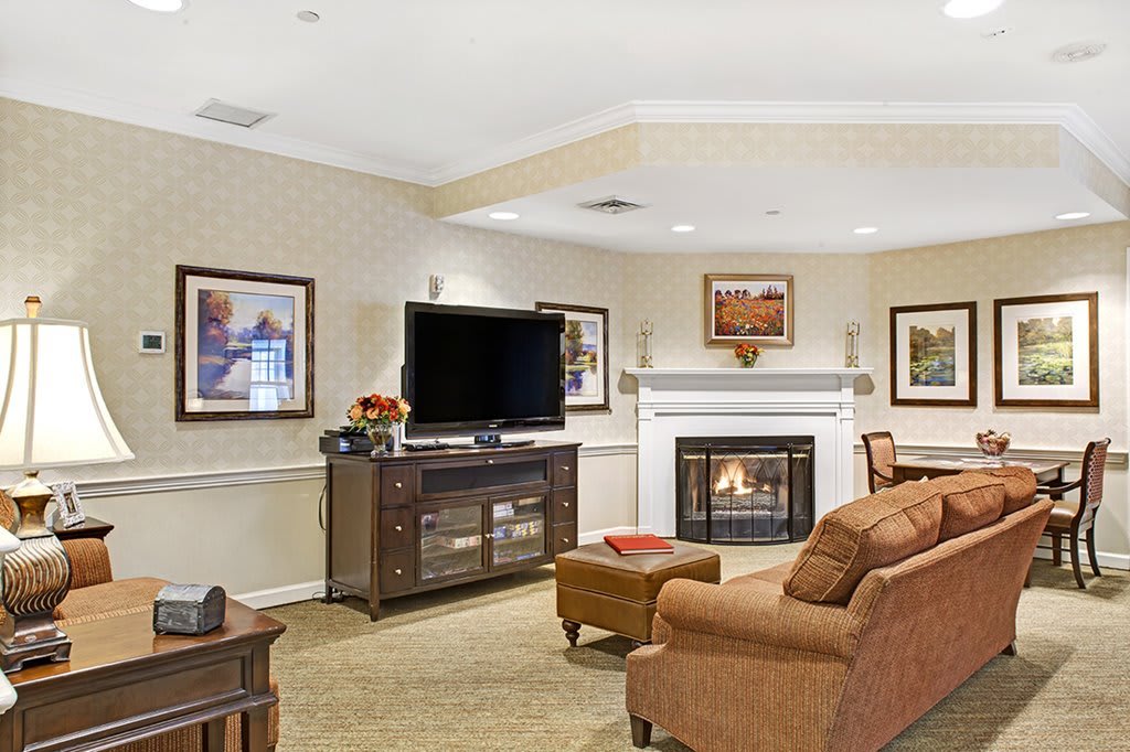A cozy living room with a fireplace, television, and comfortable seating.