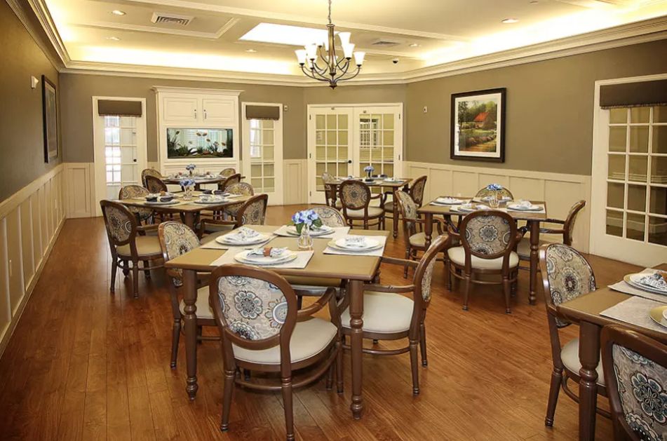 An elegantly designed dining room with wooden furniture and a chandelier.