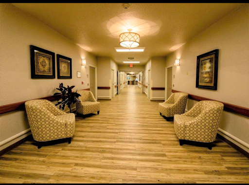 A well-lit corridor featuring patterned chairs and decorative wall art.