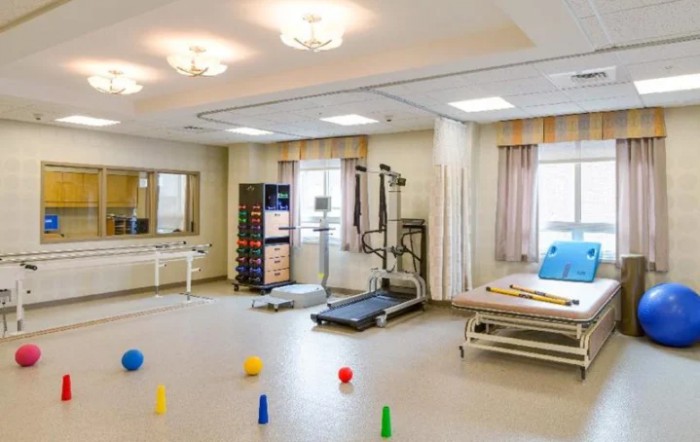 A well-equipped rehabilitation room with exercise machines and therapy aids.