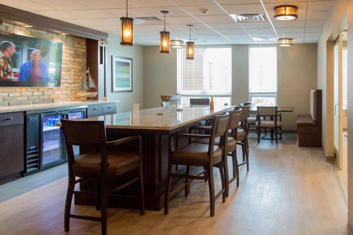 Modern bar interior with counter seating and ambient lighting.