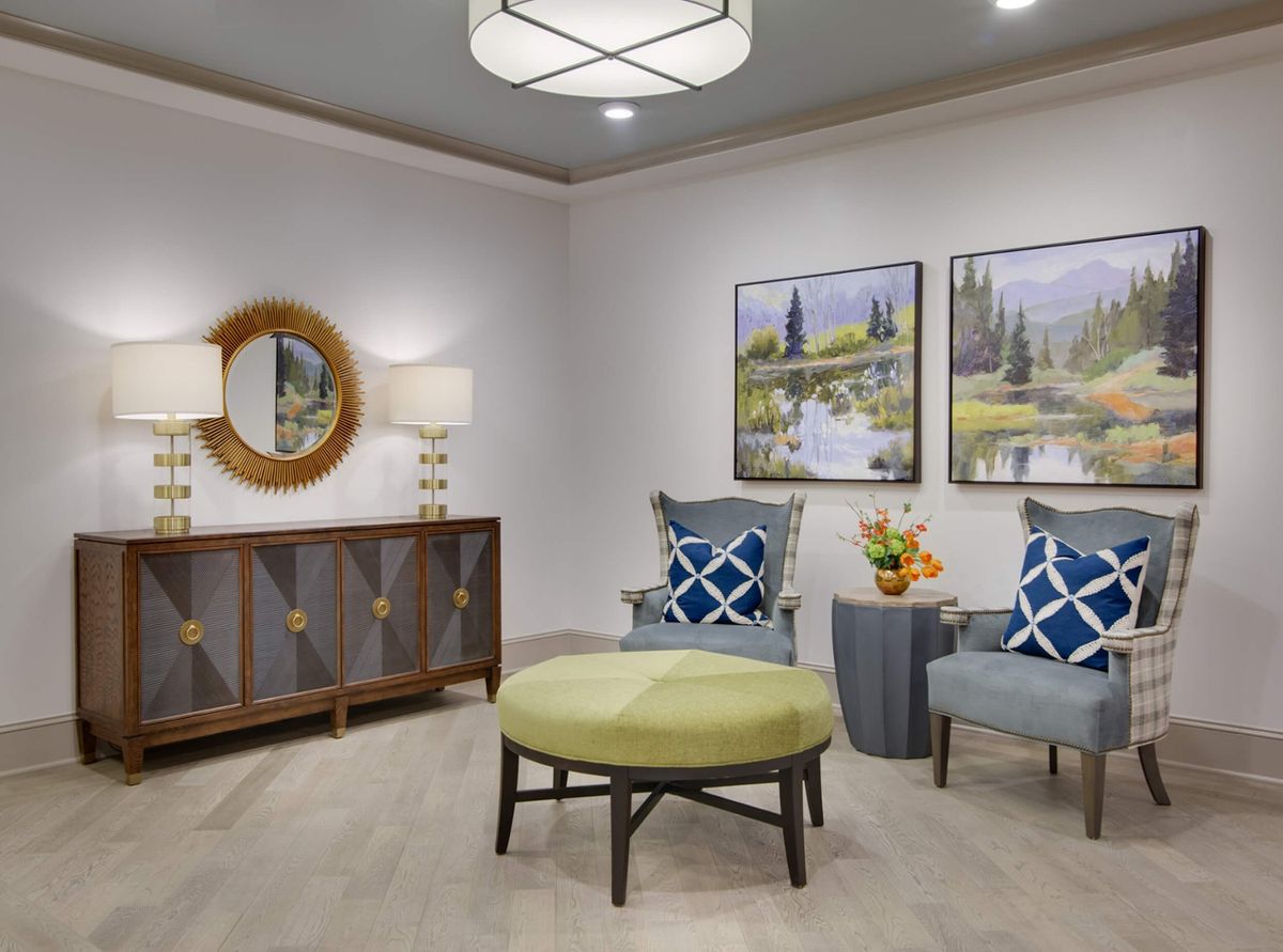 A stylish living room featuring modern furniture, decorative artwork, and a cozy seating area.