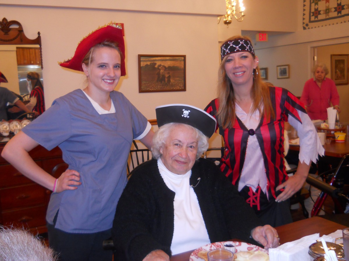 A cheerful group dressed in pirate costumes enjoying a gathering indoors.