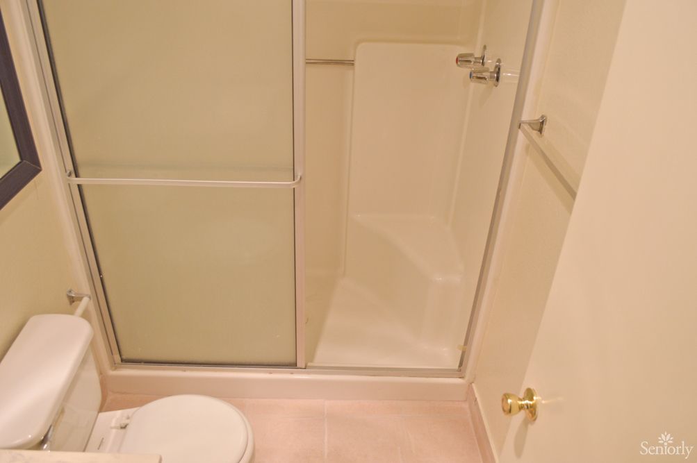 A clean and simple bathroom with a shower and toilet.