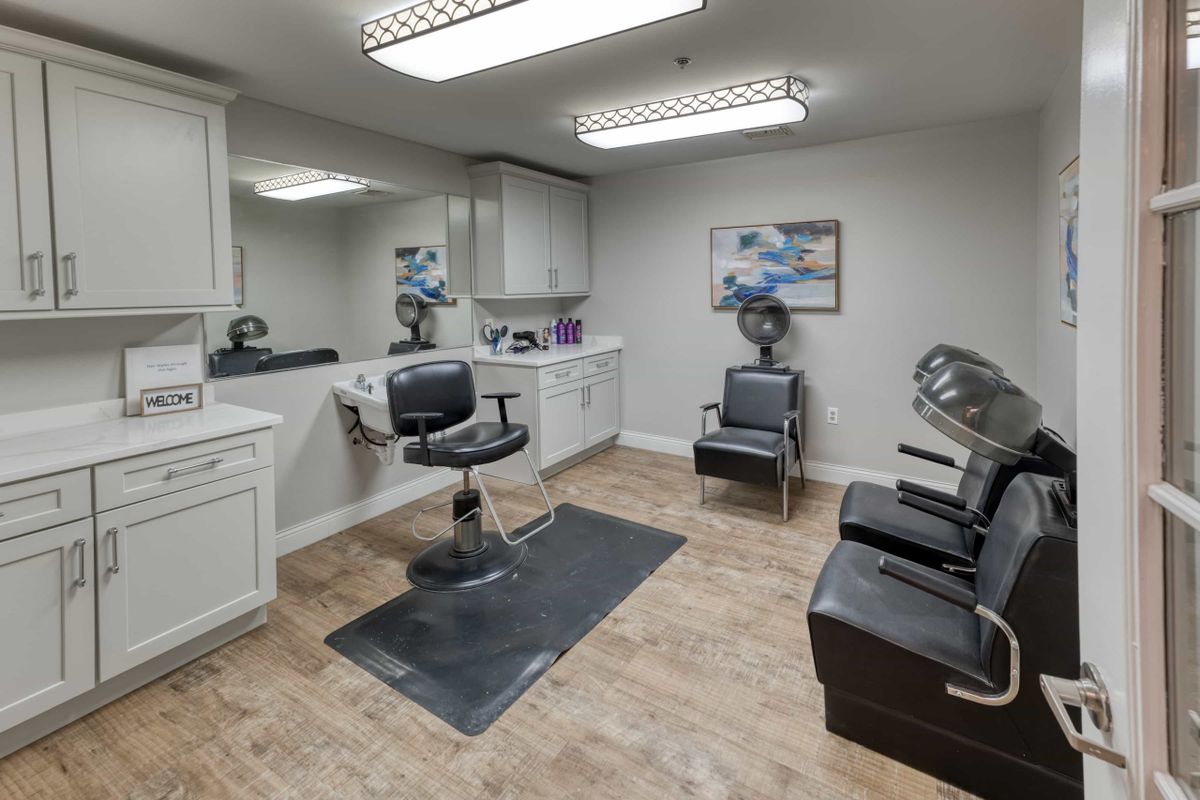 A modern and clean salon interior with hairdressing equipment.