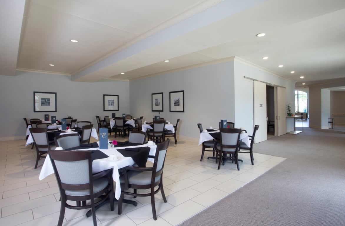 Modern dining area with neatly arranged tables and chairs.