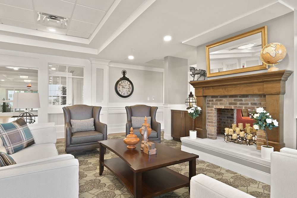 A cozy living room with elegant furniture and a brick fireplace.