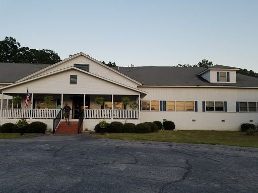A peaceful evening view of a charming residential building.