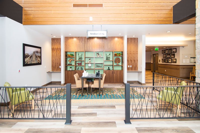 A modern lobby with a seating area and decorative wall display.
