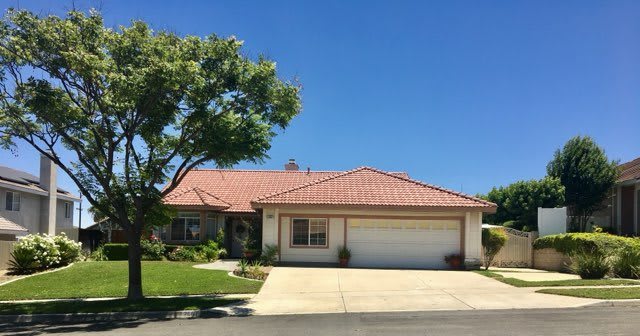 A suburban house with a two-car garage and a neatly maintained front yard.