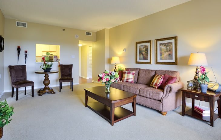 A spacious living room with a comfortable sofa, coffee table, and tasteful decor.