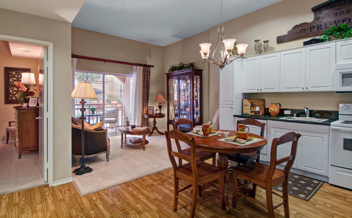 A cozy living and dining area with wooden furniture and warm lighting.
