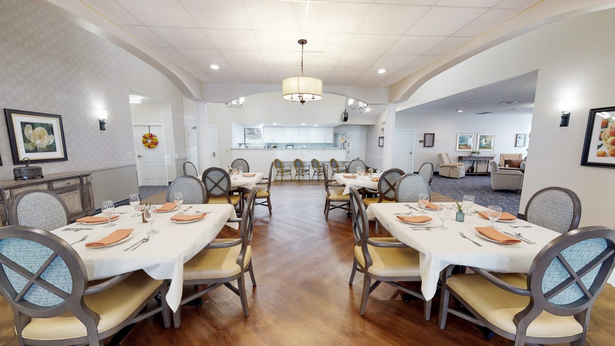 A well-decorated dining area with neatly arranged tables and chairs, featuring a bright and inviting atmosphere.