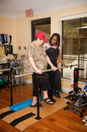 A patient receiving support during a rehabilitation exercise session.