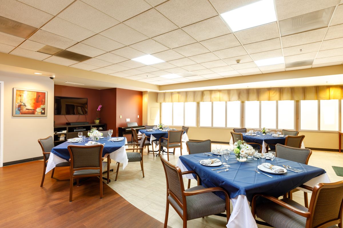 A cozy restaurant dining area with blue tablecloths and neatly set tables.